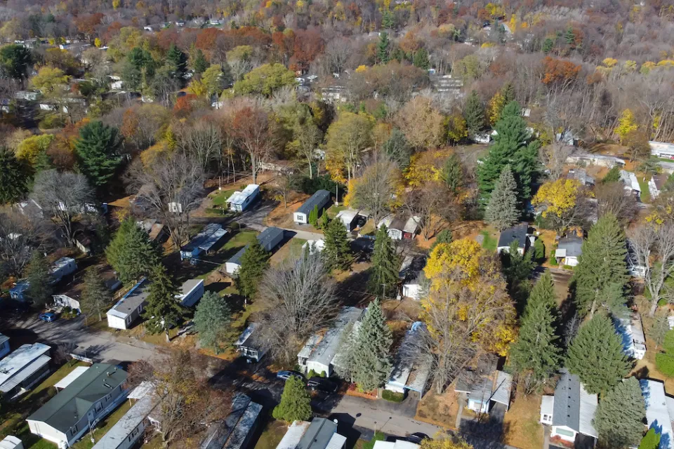 Aerial view of mobile home park with mature trees in Rochester, New York.
